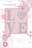 This anniversary card is designed as a tender tribute to enduring romance, its colour scheme of soft pastel pinks and silvery greys echoing the gentle tones of an English spring bouquet delivered along Alperton's tree-lined streets. At the centre, the word LOVE is formed with soft, raised glitter, giving the letters a slight three-dimensional curve that catches and diffuses light. The O is replaced by a shimmering silver heart, its textured surface denser with glitter so it stands out like a small jewel at the heart of the composition. Surrounding this focal motif, delicate blooms in blush and mauve unfurl across the card with a watercolour softness, their outlines light and fluid, suggesting petals just opening after rain. The flowers are accompanied by winding stems, slender leaves, and fine curving tendrils, which create a sense of quiet motion, as though the design is gently breathing. Tiny accents-scattered petals, looping swirls, and faint butterfly silhouettes-add to the sense of whispered movement and romantic playfulness without making the layout feel busy. The inscriptions On Our Anniversary and I love you today and always are set in graceful, understated script, their flowing lines mirroring the shapes of the vines and stems. Together, the raised glitter detailing, the softly blended floral artwork, and the elegant writing create a cohesive, tranquil mood. It feels like a card chosen with intention from a trusted local florist, ready to accompany a hand-delivered bouquet in Alperton and to mark a shared journey that is both deeply personal and beautifully understated.